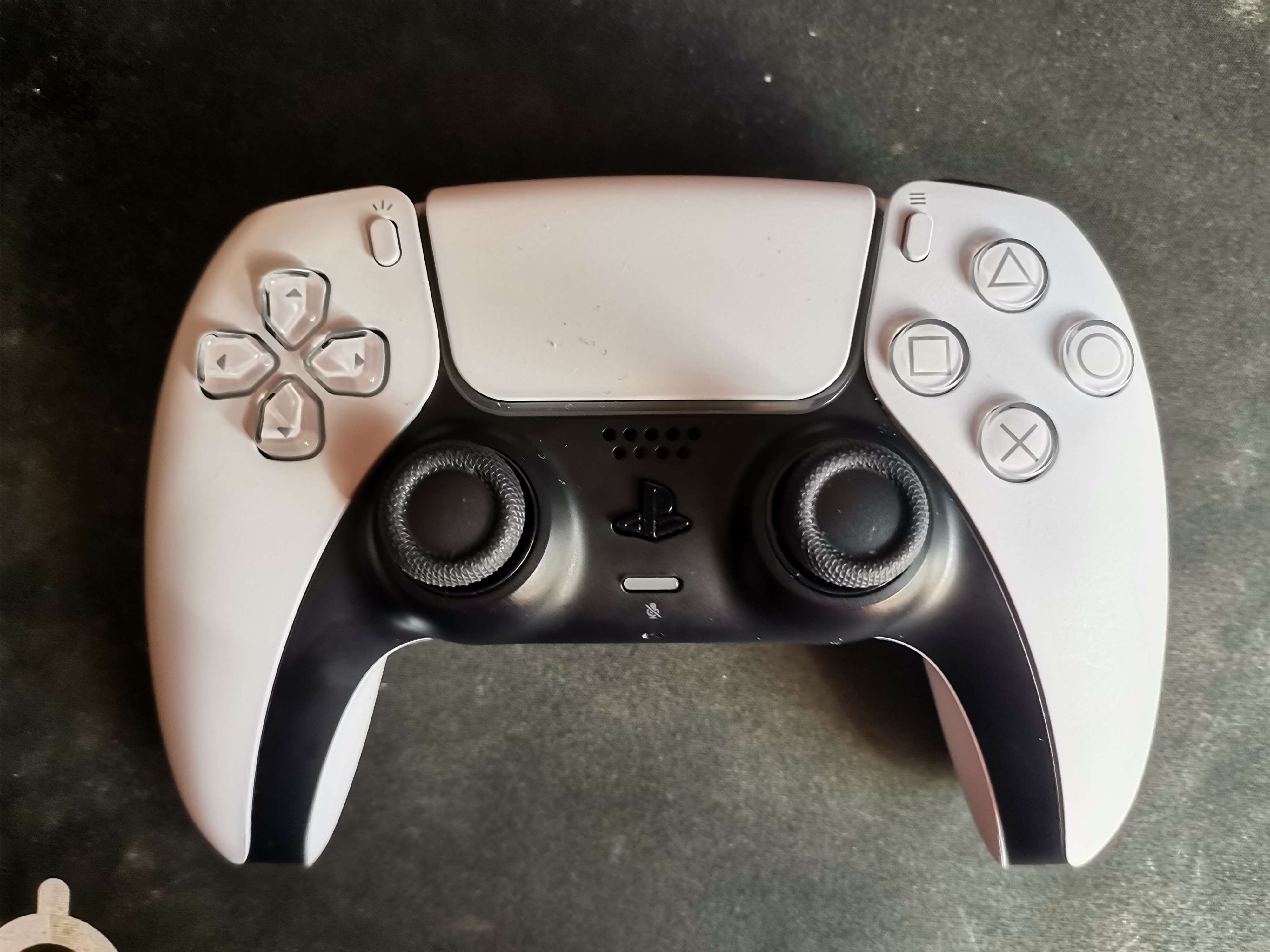 PlayStation 5 DualSense wireless controller resting on desk